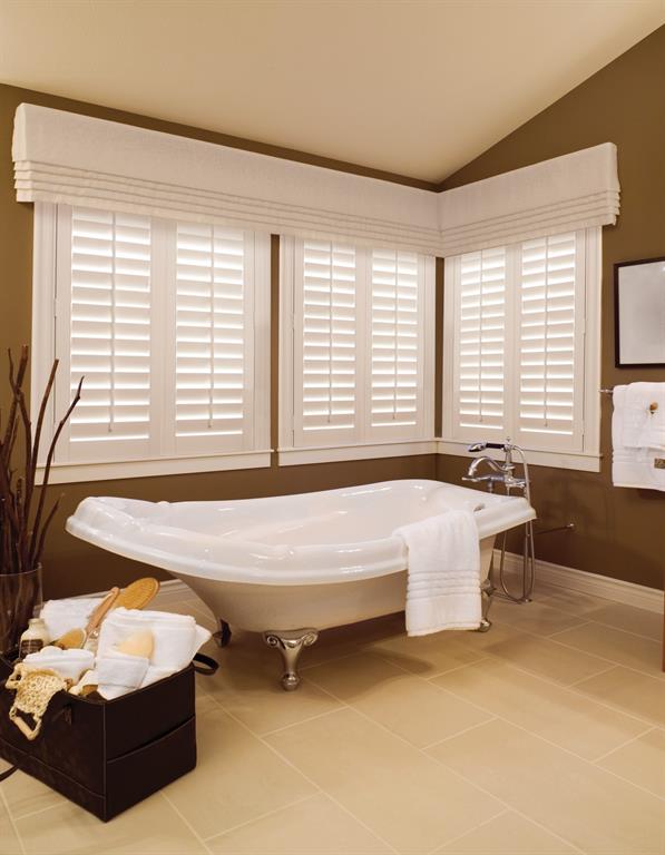 Plantation shutters stand out against a brown bathroom wall